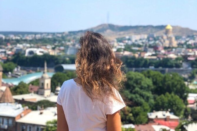 Tbilisi:Evening Walking & Talking Tour with Wine & Boat Ride - The Marionette Theater’s crooked clock tower