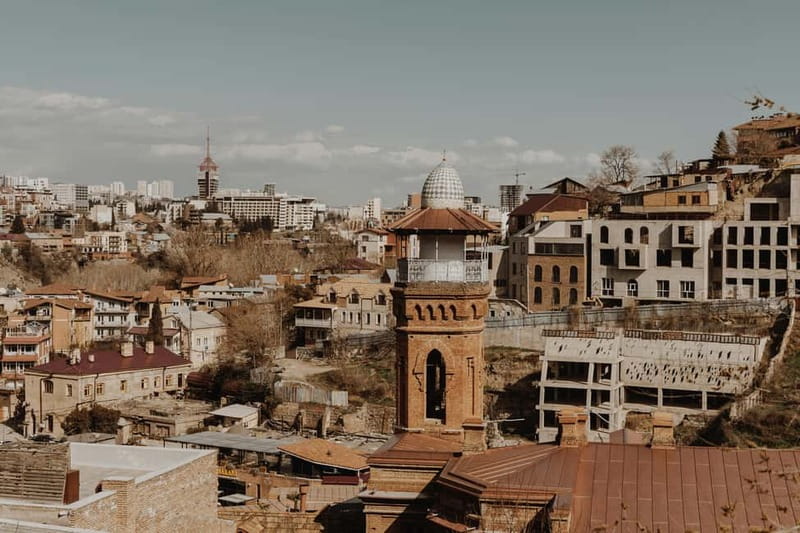 Tbilisi: Half-Day Top Sights & Attraction Tour with Tastings - Walking down from Narikala and into Abanotubani